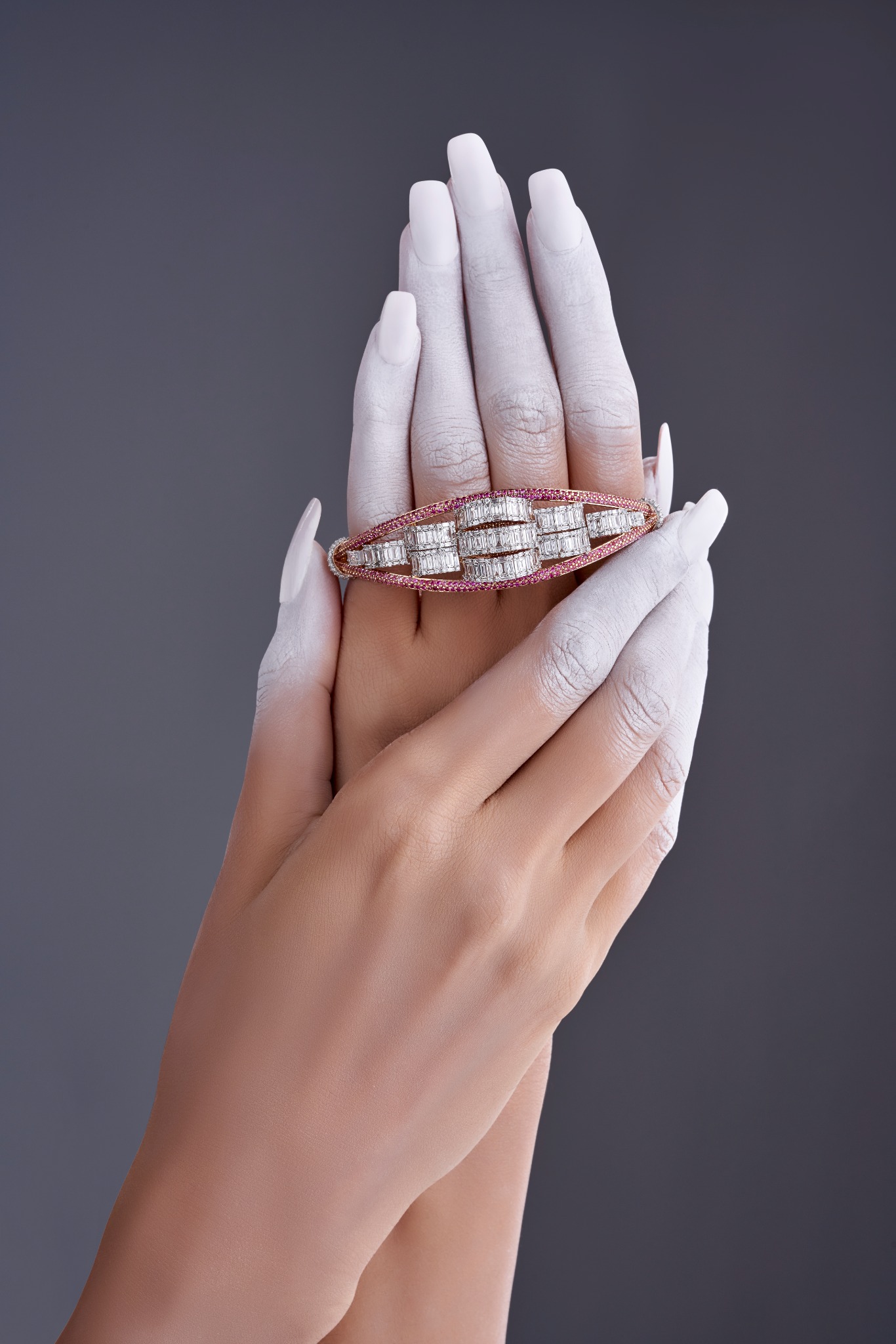 Diamond bangle with a refined pink gemstone border